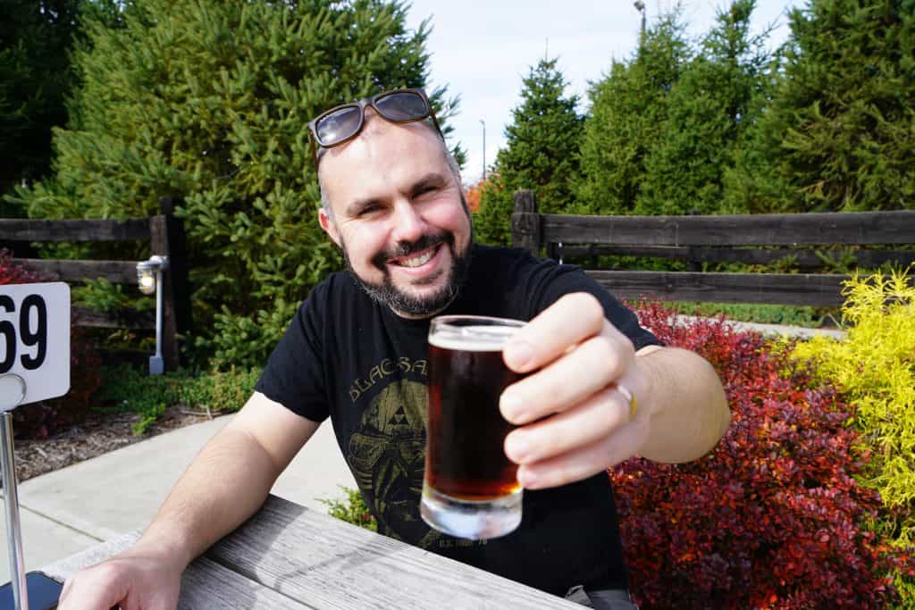 A man holding a glass of beer - The area around Shenandoah National Park has become a top destination for micro breweries and wineries | Photo: L. Merredith | RV Today